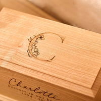 Detailed view of custom floral engraving on wooden urn.