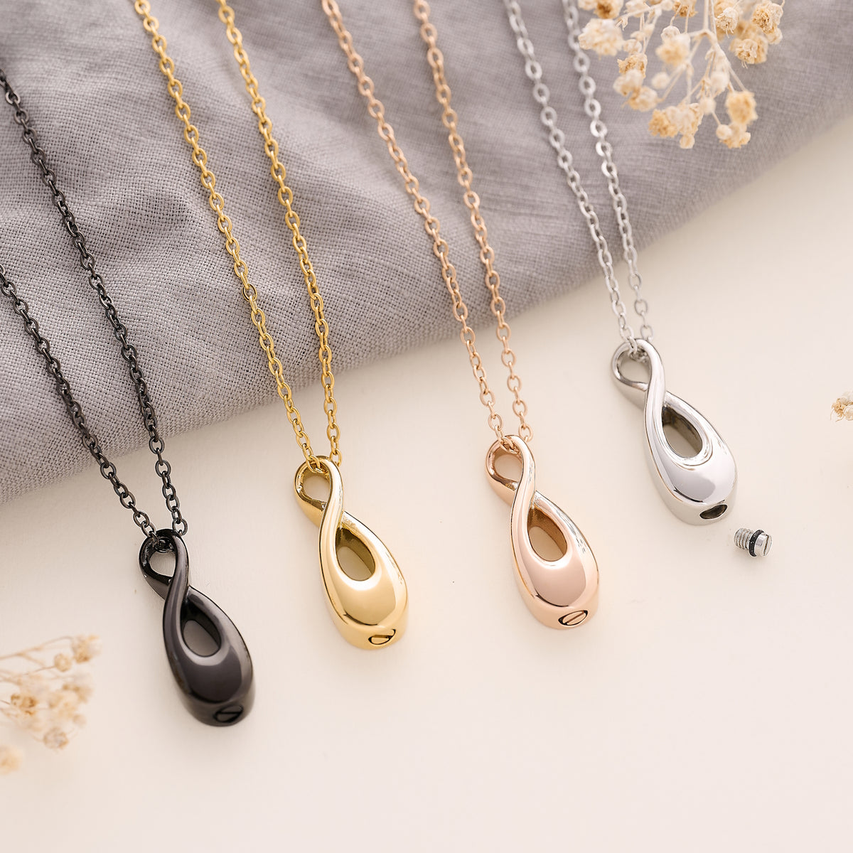 Cremation Jewellery Infinity Pendant in silver, black, gold and rose gold.