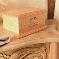 Video showing the detail on a cremation urn for a child. It is a bespoke urn, engraved with the child's name - Olivia.