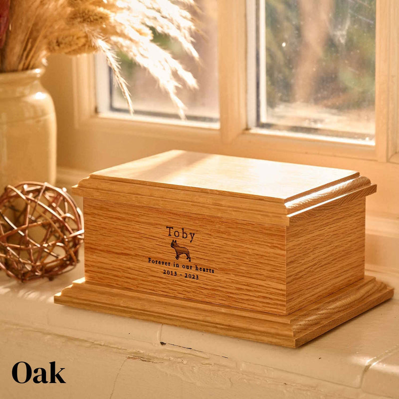 An oak dog urn with a picture of a French Bulldog engraved on it.