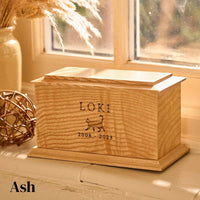 A personalised urn for a pet cat. It is a wooden urn, made of ash with the name Loki and a cat engraved on it. Cat urn. 