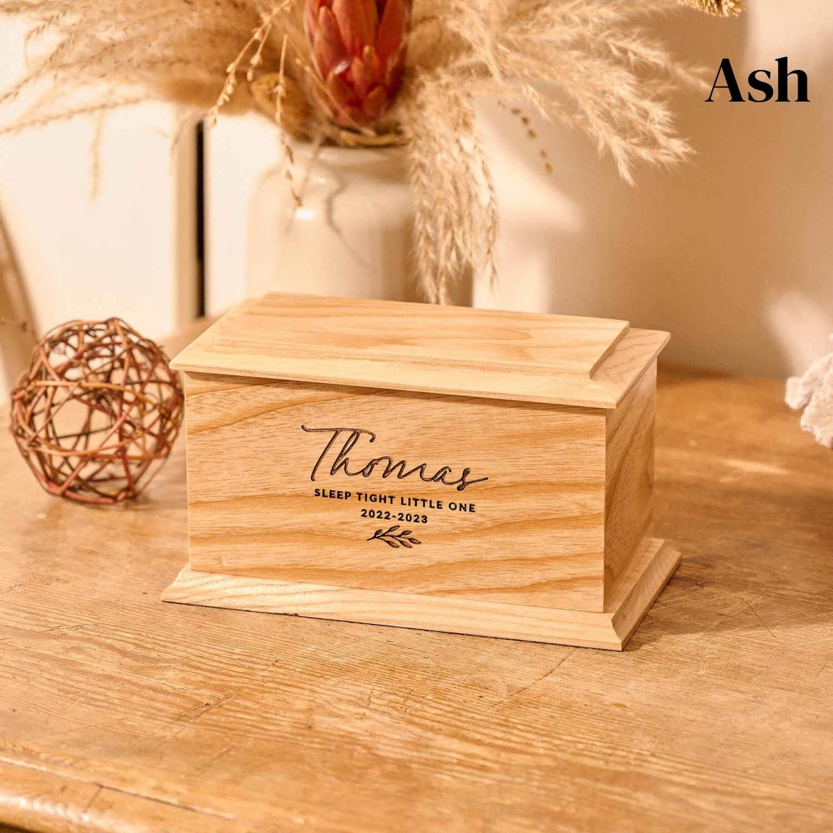 A wooden cremation urn for stillborn ashes or infant ashes