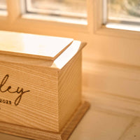 Custom Pet Cremation urn with paw print engraved - Made from solid ash wood - Cremation urn for pet ashes - Thicket Memorials