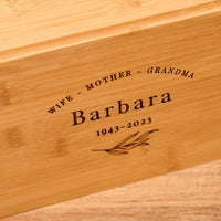 Close up of an urn for mum or an urn for grandma. The name barbara is engraved on the wooden urn.